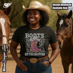 Smiling woman wearing rhinestone “Boots on the Ground” t-shirt with western boots and hat design for Cricut machines