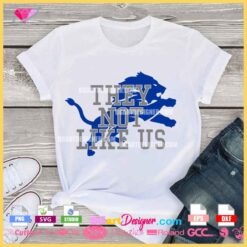 Detroit Lions-inspired "They Not Like Us" SVG design on a white t-shirt mockup, showcasing a bold blue lion graphic and layered text for Cricut and Silhouette users.